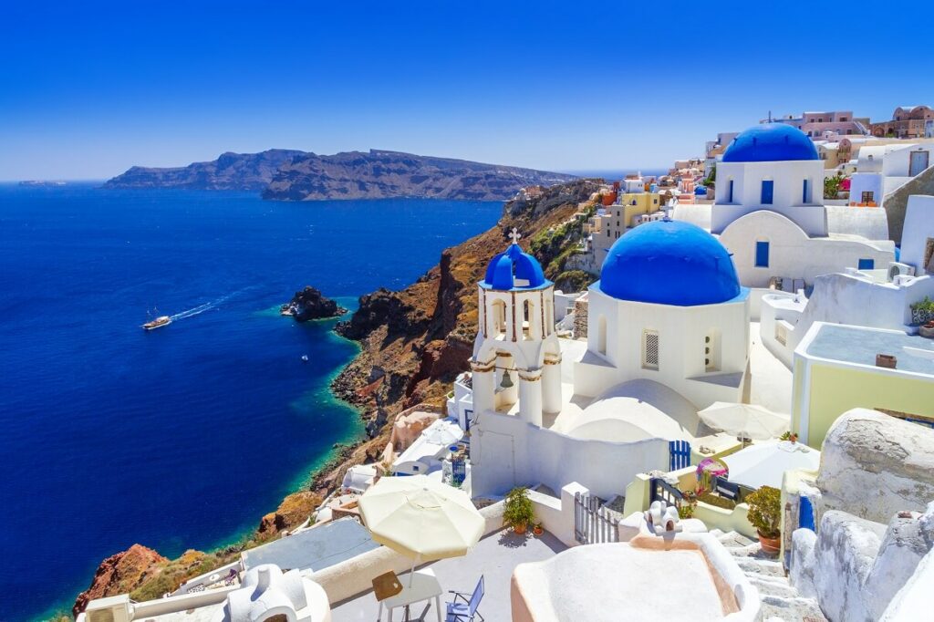 Les maisons blanches et dômes bleus de Santorin, en Grèce, une destination romantique du Top 5 des lieux à voir avant de mourir.